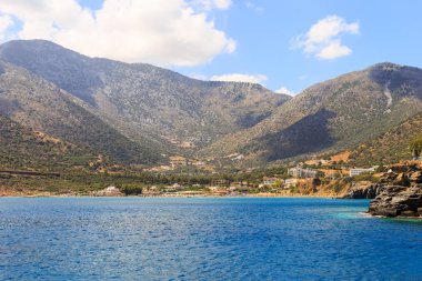 Deniz tatil köyü Bali Körfezi. Dalgalar ve şezlonglar tarafından yıkanmış dağ, kıyı, görünümlerini.