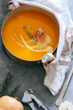 Güveç jambon ve gri bir arka plan üzerine kekik ile kabak çorbası