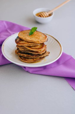 Bal ve nane, bal ayı beyaz bir arka planda menekşe Tekstil ile muz krep. Sabah kahvaltı