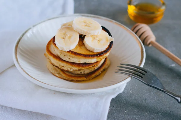 Delicious pancakes with banana and honey for a breakfast