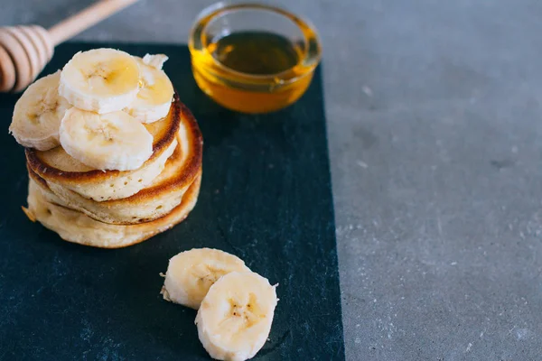 Delicious pancakes with banana and honey for a breakfast