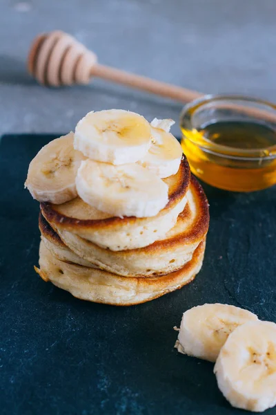 Delicious pancakes with banana and honey for a breakfast