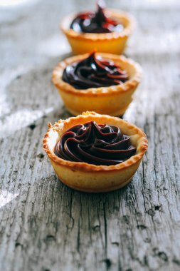 Kırmızı tartlets kek çikolata ganache ahşap zemin ile yapılmış