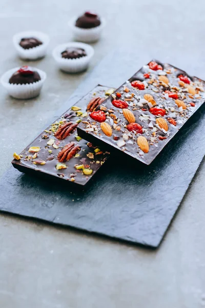 Ham ev yapımı çikolata fındık, cranberris siyah arka plan üzerine