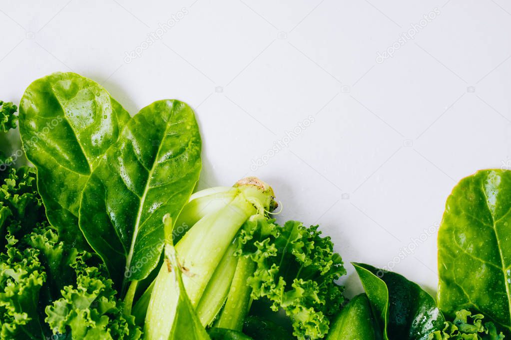 Frame of fresh green vegetables on a marble background, copy space, flay lay, top view