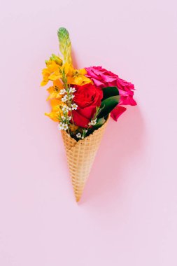 Pembe arka plan üzerinde renkli buket ile Düz dondurma konileri yatıyordu, kopya alanı