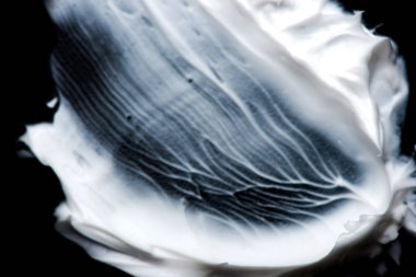 krem yakın çekim doku. Karalama siyah bir zemin üzerine krem