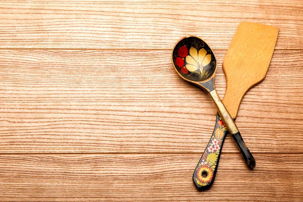 a wooden spoon and a wooden spatula. kitchen set