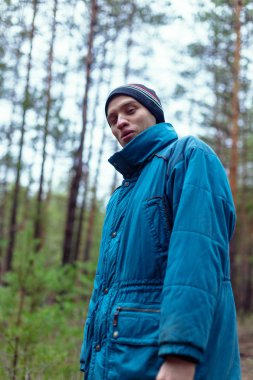 Kırsal bir adam bir çam ormanında sonbahar zamanında poz