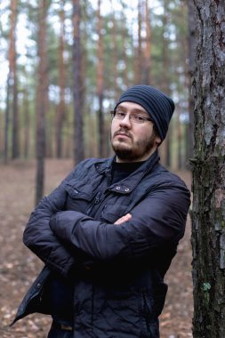 Bir çam ormanı şişko bir genç adam portresi.