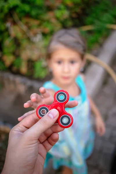 Little Girl Runs Hand Red Fidget Spinner — Stock Photo, Image