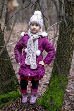 Sonbahar bir ormanda yakınındaki poz küçük şirin kız