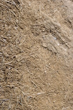 Kil ve saman yapılmış eski bir ev eski bir duvar dokusu.