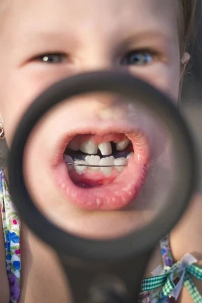 Liten Flicka Sätta Ett Förstoringsglas För Munnen För Att Visa — Stockfoto