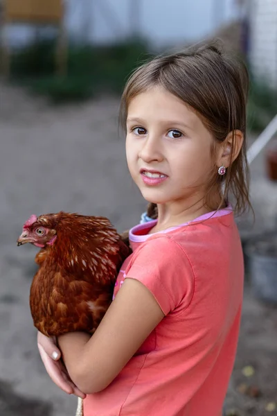 Little rural girl with chicken in her arms — Stock Photo, Image