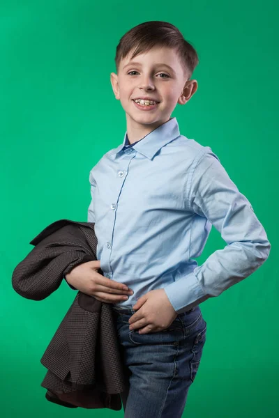 Schoolboy posing on a green background — Stock Photo, Image