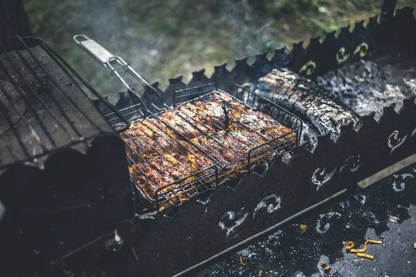 Frango marinado grelhado em uma grade metálica — Fotografia de Stock