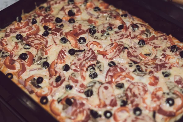 Delicious pizza with cheese and olives. Toned style photo. Pizza — Stock Photo, Image