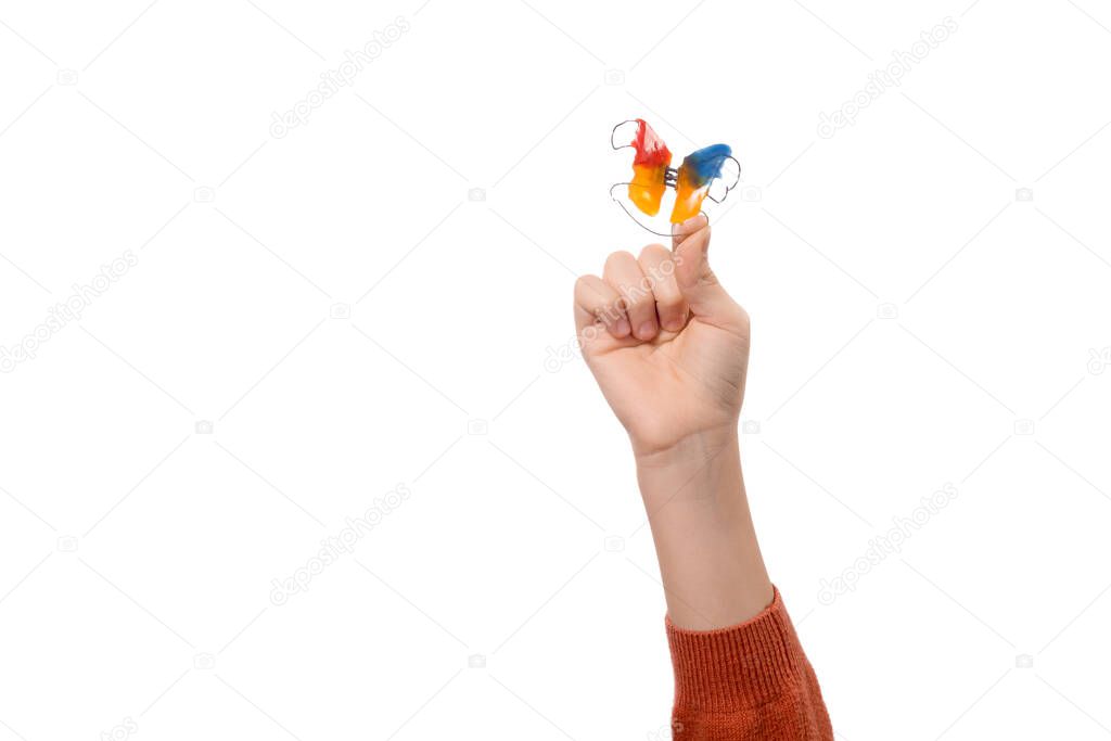 Child's hand with orthodontic appliance isolated on a white background