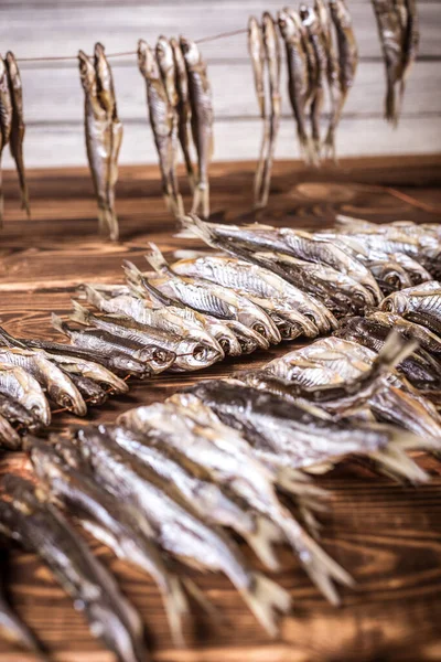 Small Dry Fish Rope Wooden Background Studio Photo — Stock Photo, Image