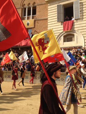 Siena, İtalya - 02 Haziran 2012: turist, at yarışı, renkli ve süslü geleneksel kostüm geçit izlerken Palio di Siena, tutulan Ortaçağ kare Piazza del Campo için yapılan yılda iki kez Siena.