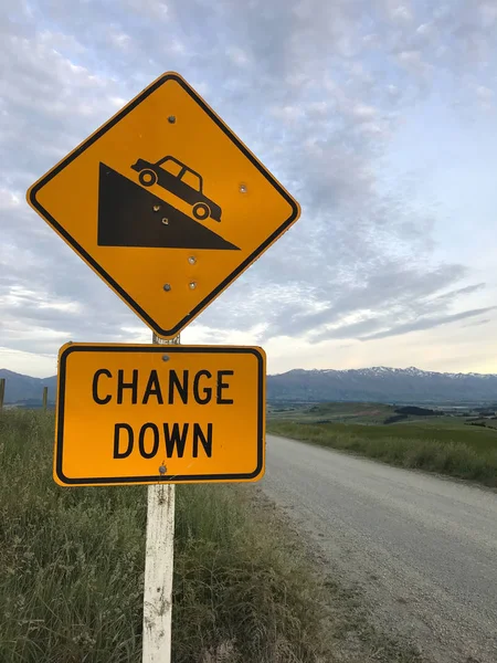 Traffic Sign: Steep descent sign on yellow background. The road descends. Warning signs let you know road changes are coming up on your drive, you should slow down and approach the bend with caution