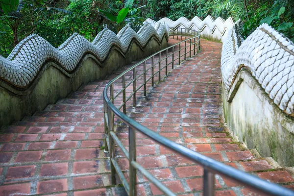 Safety Handrail help climbing down Two Naga Guardian stairway downhill from Wat Phra That Doi Tung temple, Chiang Rai, Thailand. Thai Travel Traditional and cultural Thai tourism, tourist destination.