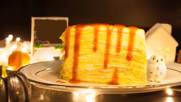 tasty homemade sweet food dessert Strawberry Crepe Cake decorating with festive Halloween theme background. Sweets, treats, snack, bakery, pastry dessert decoration in Halloween Holidays Festival.