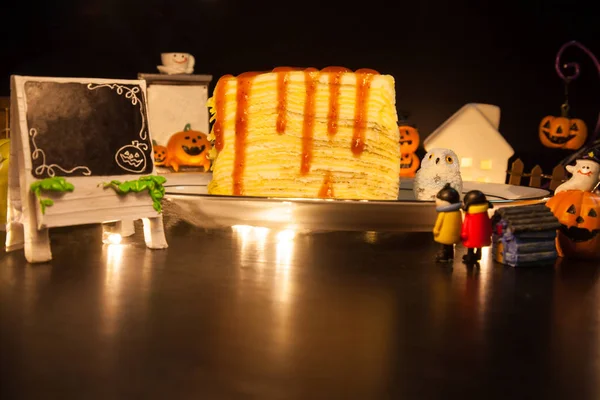 tasty homemade sweet food dessert Strawberry Crepe Cake decorated in festive Halloween background with copy space. Sweet, treat, snack, bakery, pastry dessert decoration in Halloween Holiday Festival.