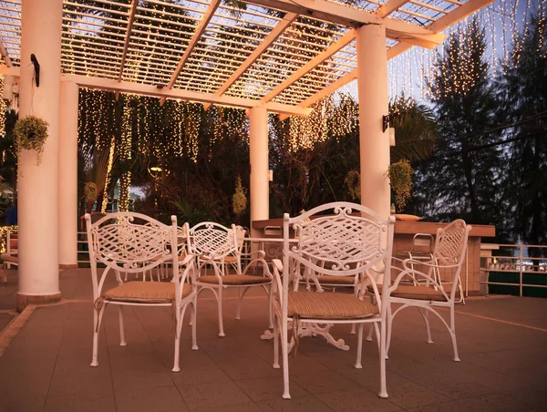 white outdoor exterior park garden party table and chairs with warm light illumination decoration ceiling, architecture house home furniture design concept