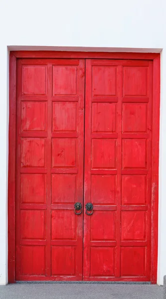 Red vintage retro wooden door on white wall background. Home interior architecture design, plain tropical textured wood panel board in old traditional boutique Asian house, Wallpaper, backdrop concept