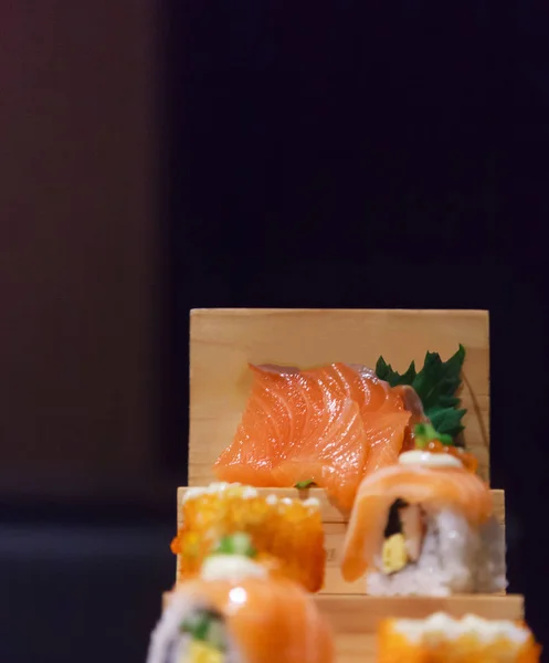 Japanese Fresh Fish Food Dish Menu,  Salmon Sushi and Sashimi Assortment decorating on wooden steps in traditional Japanese Restaurant. Healthy Food rich with fish nutrition and Delicious meal concept