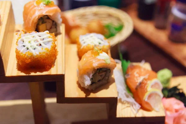 Japanese Fresh Fish Food Dish Menu,  Salmon Sushi and Sashimi Assortment decorating on wooden steps in traditional Japanese Restaurant. Healthy Food rich with fish nutrition and Delicious meal concept