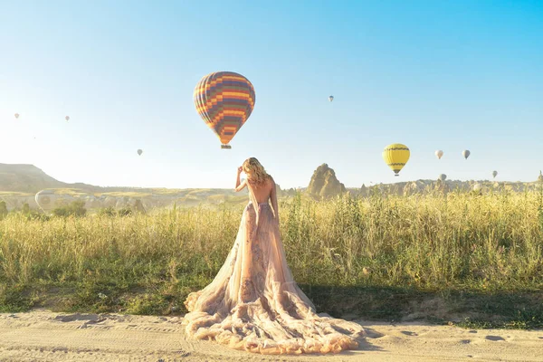Woman in a dress on a background of balloons in Cappadocia, Turkey