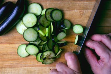 Kesme tahtasındaki bıçakla patlıcanları kesmenin en iyi görüntüsü.