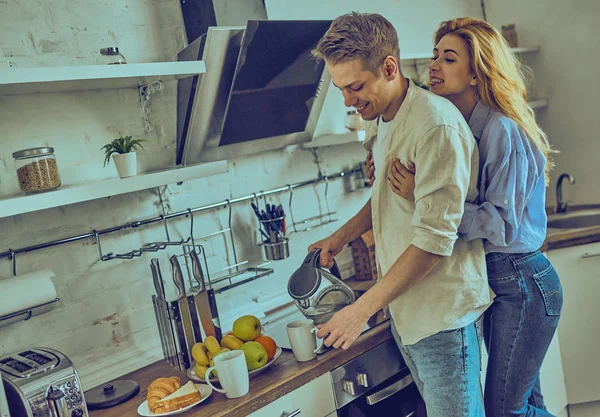 Romantic young couple cooking together in the kitchen, having a great time together. — Stock Photo, Image