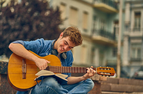Busy talented musician writes a new song into notebook.