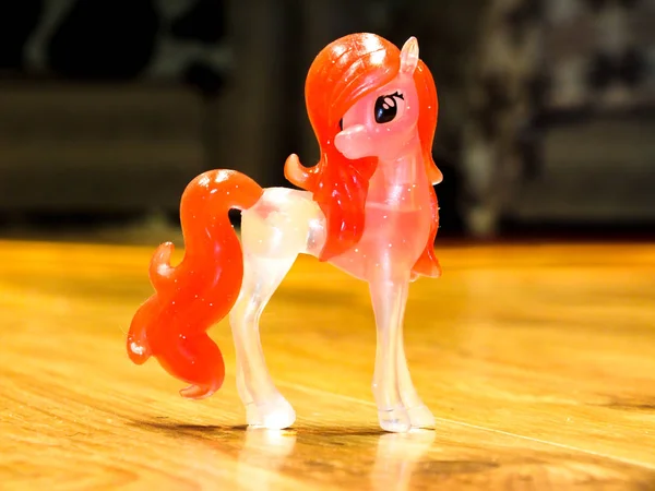 Pink pony toy on blurred background