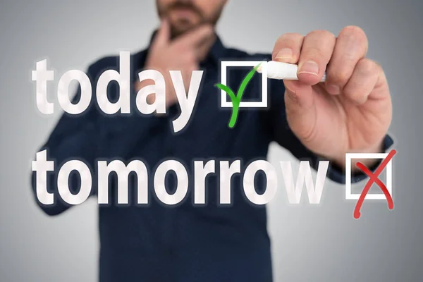 man with pen choosing between today and tomorrow anti procrastination concept