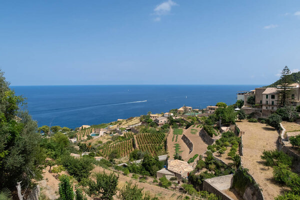 historic village of Banyalbufar on Mallorca, Spain against blue sky and sea