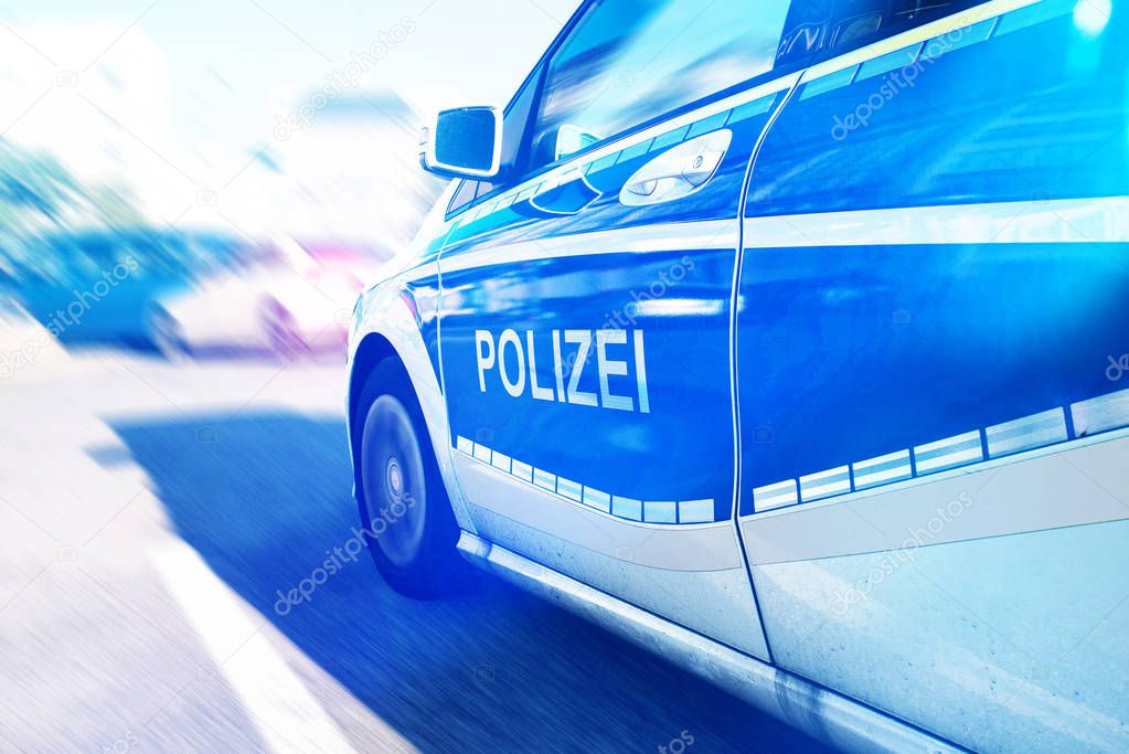 close-up of German police car with flashing blue light on street