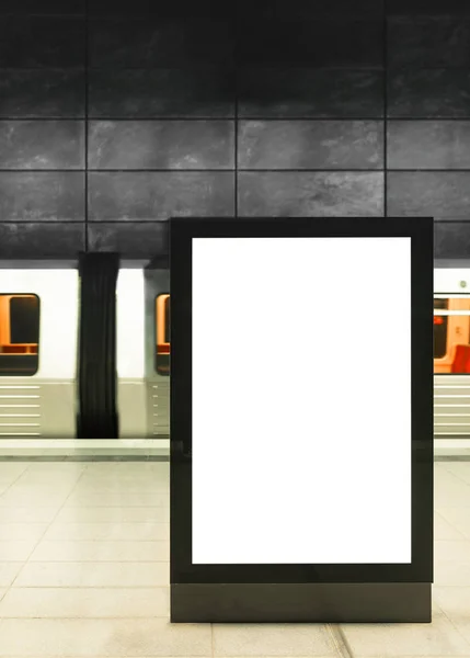 Illuminated digital billboard in underground train station — Stock Photo, Image