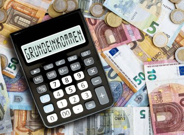 Almanca kelime Grundeinkommen, temel gelir, cep hesap makinesine karşı nakit para tablo görünümünü üzerinde yazılı