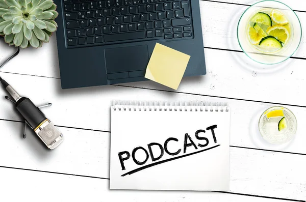 Podcast recording concept with laptop computer and microphone on rustic wooden table — Stock Photo, Image