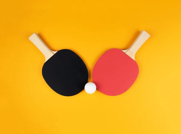 directly above shot of two table tennis rackets and ball