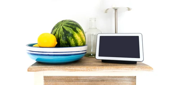 smart display and smart speaker on kitchen shelf