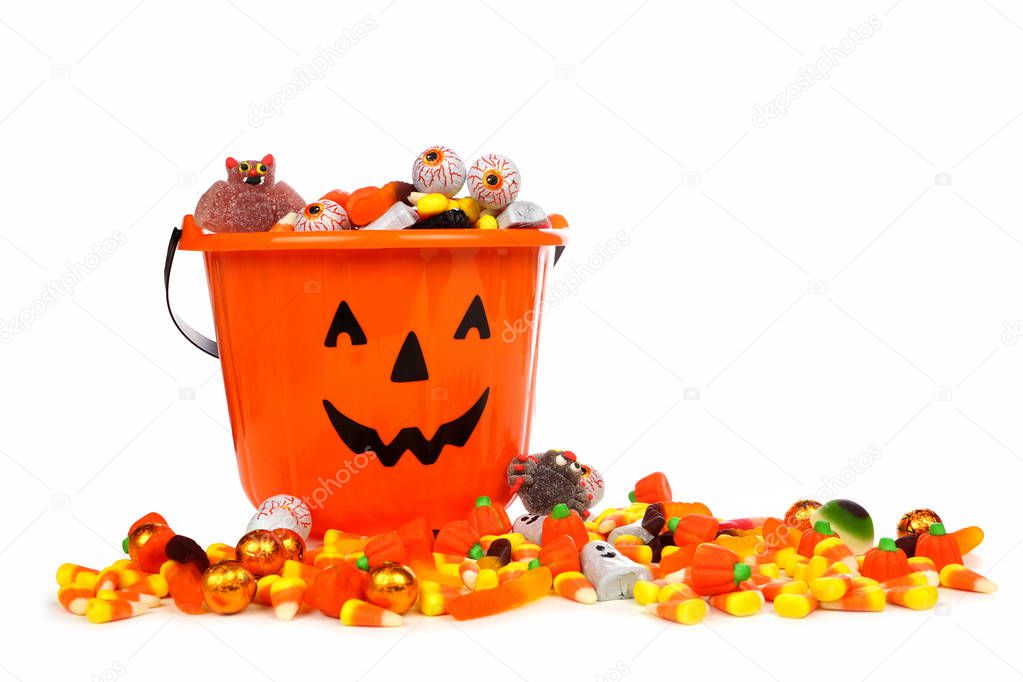 Halloween Jack o Lantern candy collector with a pile of candy over a white background