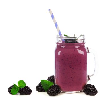 BlackBerry güler yüzlü bir mason kavanoza cam üzerinde beyaz izole saman ve dağınık çilek ile