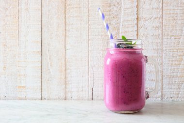 BlackBerry güler yüzlü bir mason kavanoza cam rustik bir beyaz tahta arka plan üzerinde