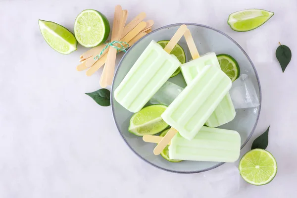Healthy Lime Yogurt Popsicles Plate Top View Marble Background — Stockfoto